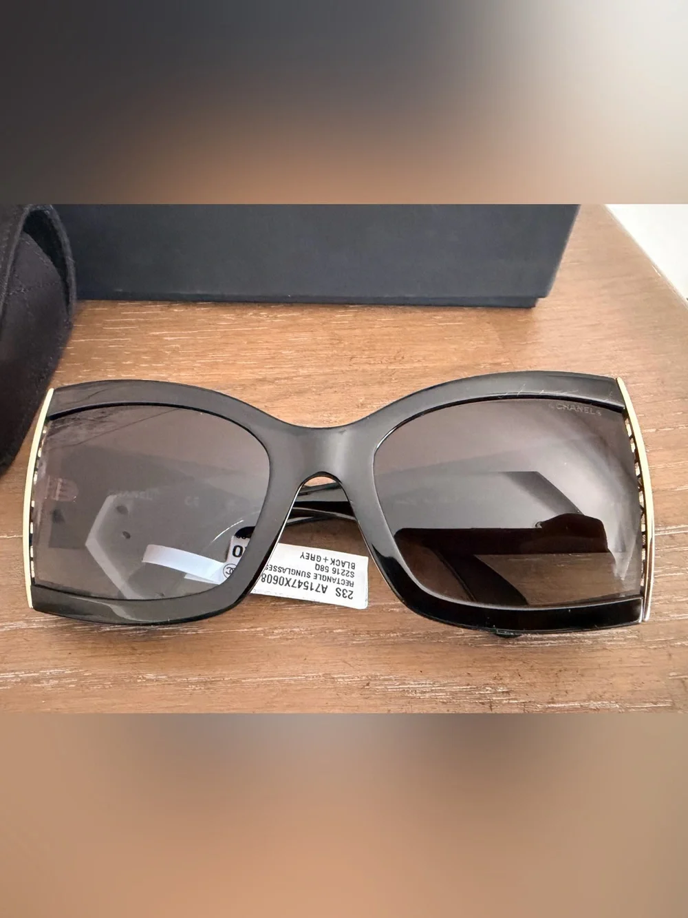 CHANEL Black Cat-Eye Sunglasses with Gold Accent and Gradient Gray Lenses